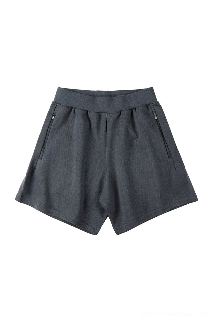 Dark slate gray cotton blend sweat shorts with loose casual silhouette, elastic ribbed waistband, and practical side zipper pockets
