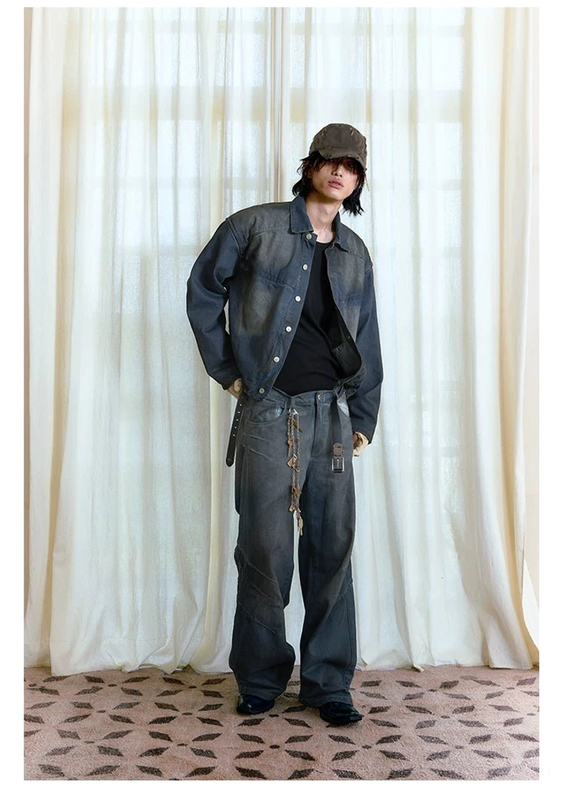 Three-quarter full body view of dark vintage wash distressed stacked wide-leg jeans styled with black top and cap
