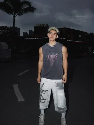 Full body Asian male model wearing a dark washed grey sleeveless graphic muscle tank with cropped cargo pants in a Seoul streetwear outfit