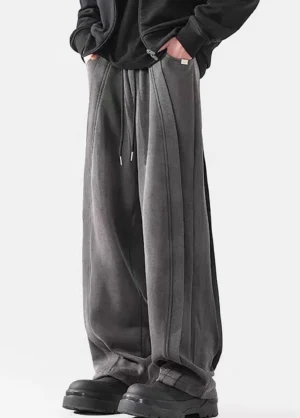 Three-quarter view of dark washed wide-leg drawstring pants with relaxed Korean streetwear styling