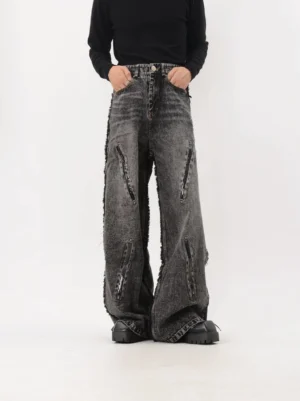 Front full-body view of dark acid-wash deconstructed wide-leg jeans with raw seams, elongated zipper accents, and chunky platform shoes