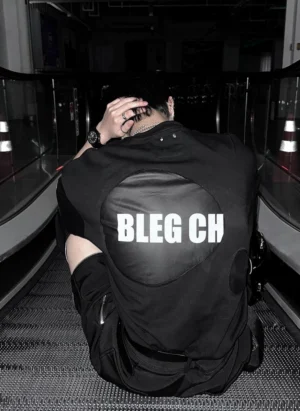 Rear view of deconstructed back patch oversized black street tee showing large contrast graphic panel and split sleeve construction