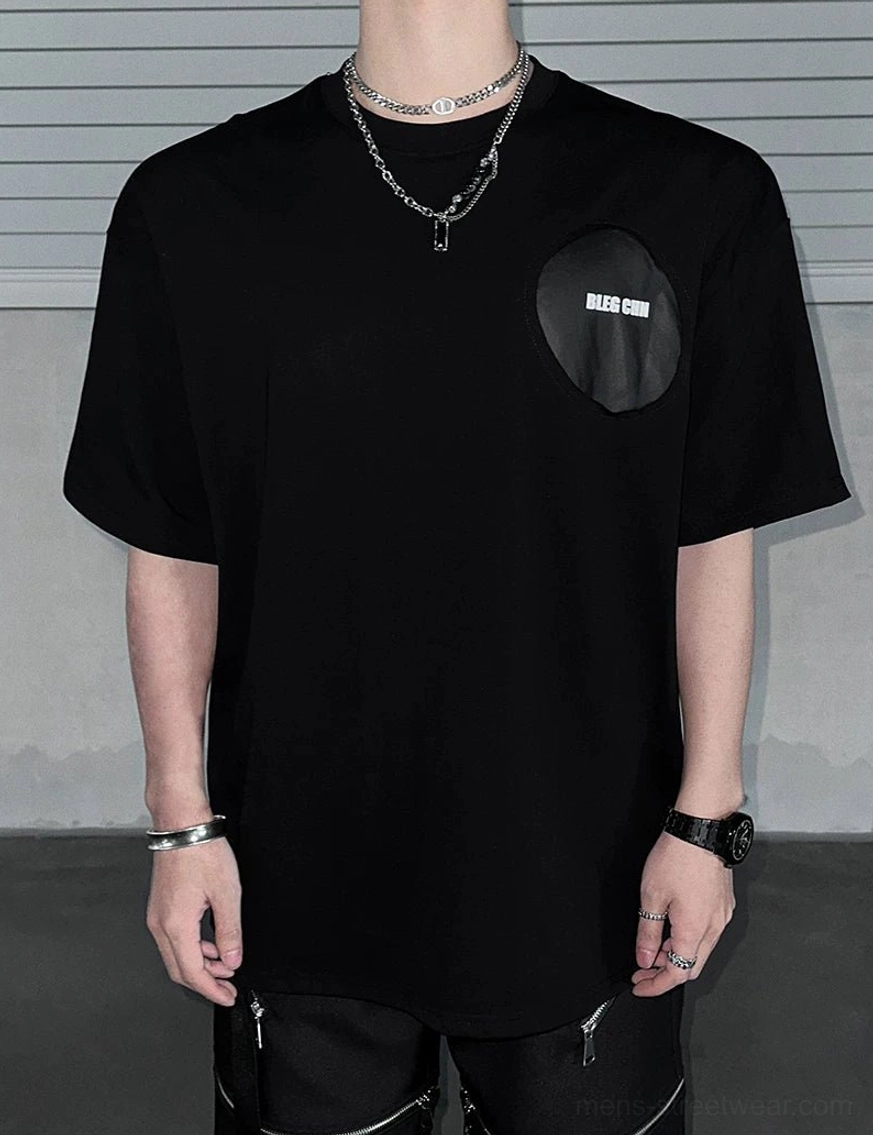 Deconstructed back patch oversized black street tee styled for modern Seoul inspired urban fashion