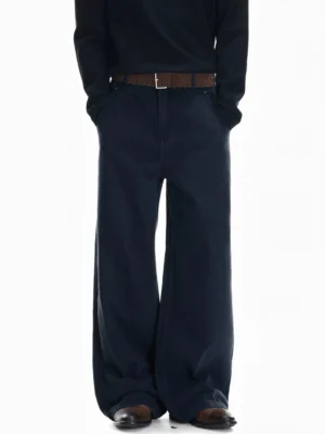 Front view of deep navy wide-leg canvas pants styled with a black top, leather belt, and relaxed East Asian streetwear silhouette