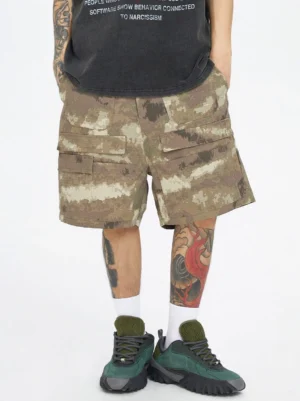 Front view of desert digital camo multi-pocket cargo shorts styled with a graphic streetwear T-shirt