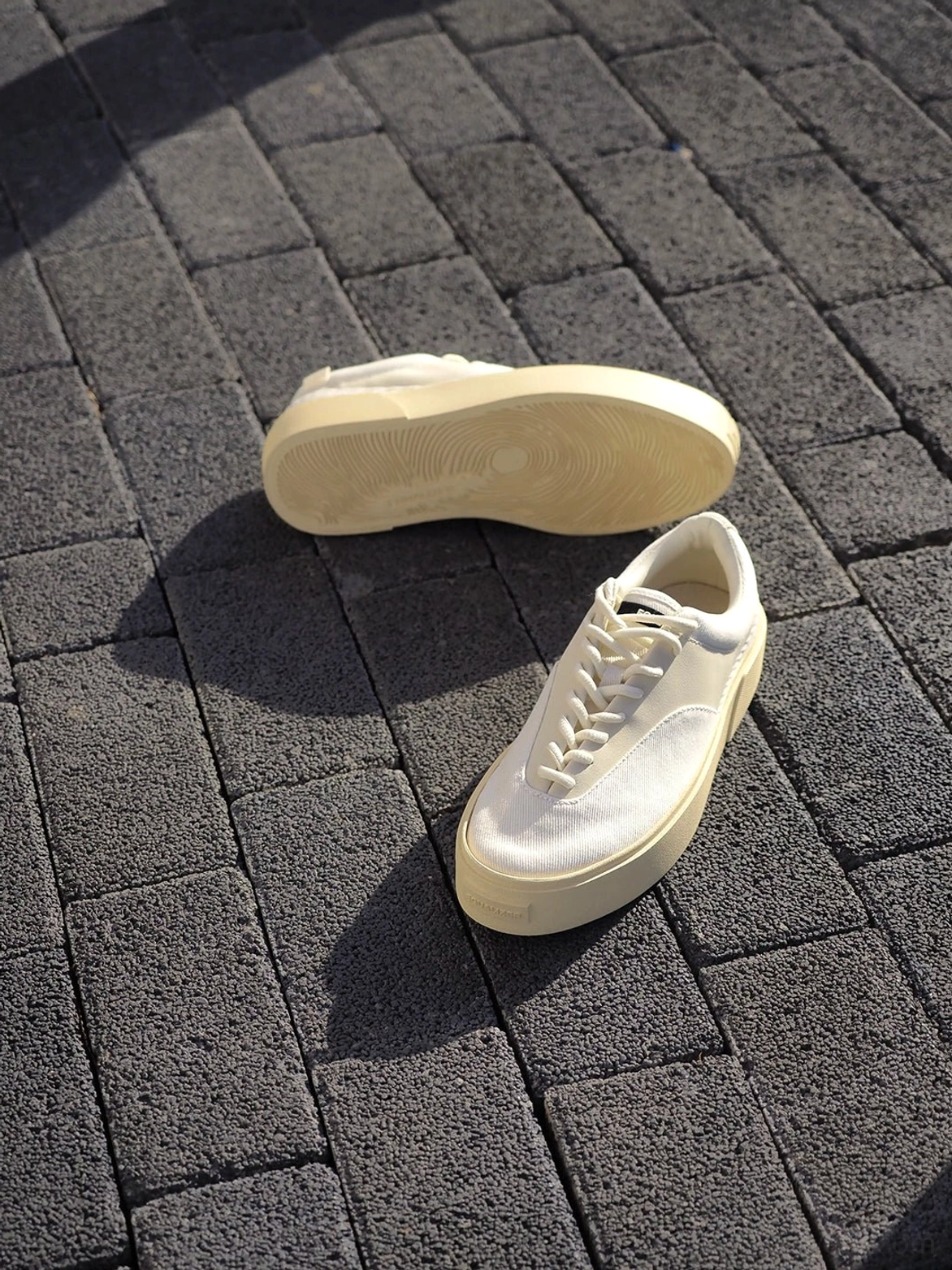 Overhead view of Desert Gray platform canvas trainers showing cream outsole tread and layered side profile
