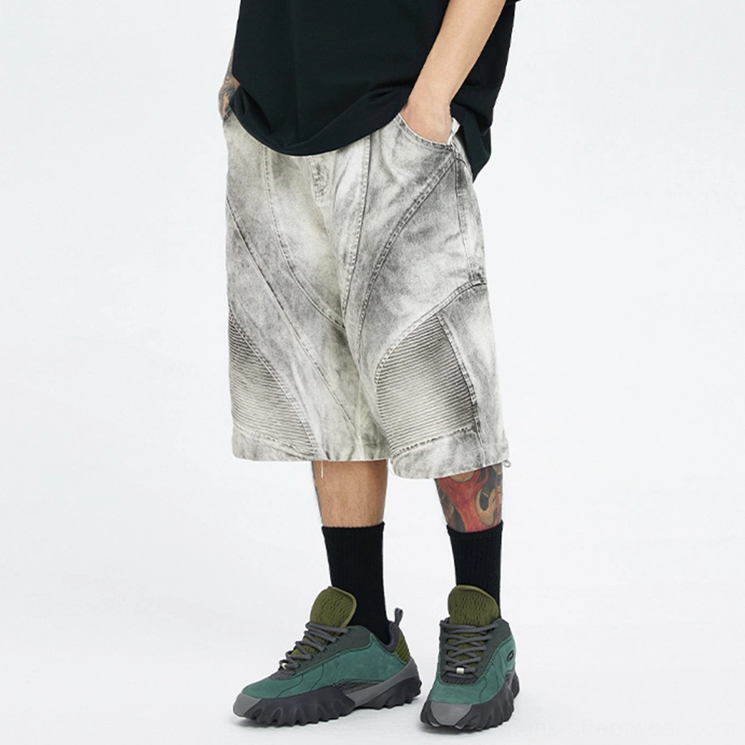 Side rear view of detachable leg moto cargo shorts with faded ash grey wash, wide cropped fit, ribbed knee panels, and cargo styling