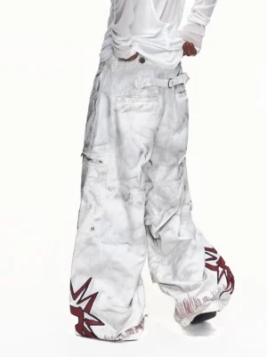 Rear model view of off-white washed wide-leg cargo pants showing adjustable back waist belt, frayed hems, and red star leg graphics