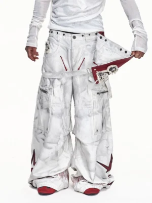 Front low-angle model view of washed off-white detachable red apron wide-leg cargo pants with oversized utility pockets and red star graphics