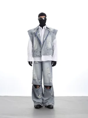 Full-body model wearing a distressed acid-wash denim vest and wide-leg jeans set with ripped details and knee cutouts