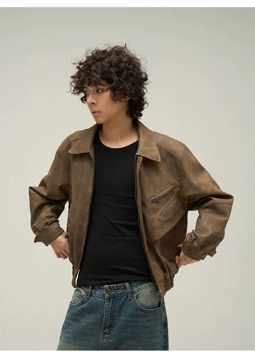 Side half-body view of a man wearing a distressed brown faux leather jacket with chest zipper pocket and relaxed streetwear fit