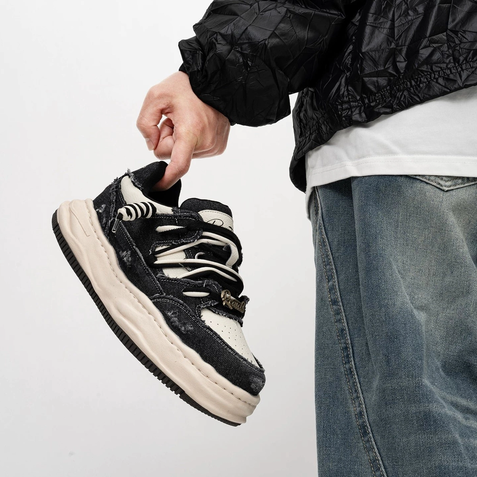 Close side view of black distressed canvas platform skate sneaker with double laces and frayed details