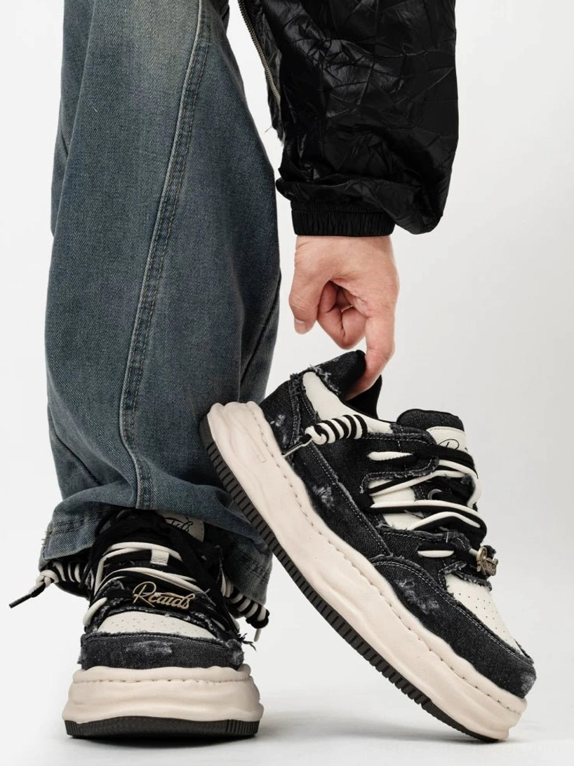 Black and white vintage distressed canvas platform sneakers rear view with thick cream rubber sole