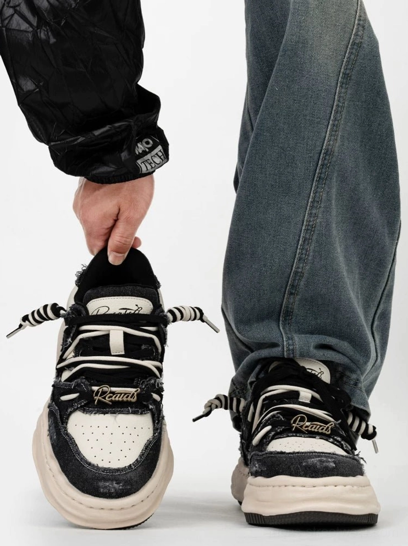 Black and white distressed canvas platform skate sneakers worn with baggy blue jeans in Korean streetwear outfit