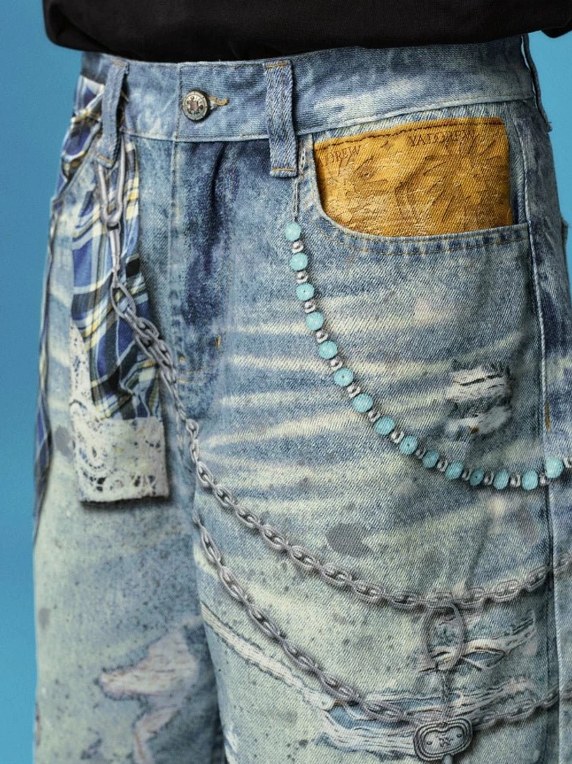 Close-up detail of distressed denim jorts waist and pocket with layered metal chains, turquoise beads, plaid fabric and acid wash