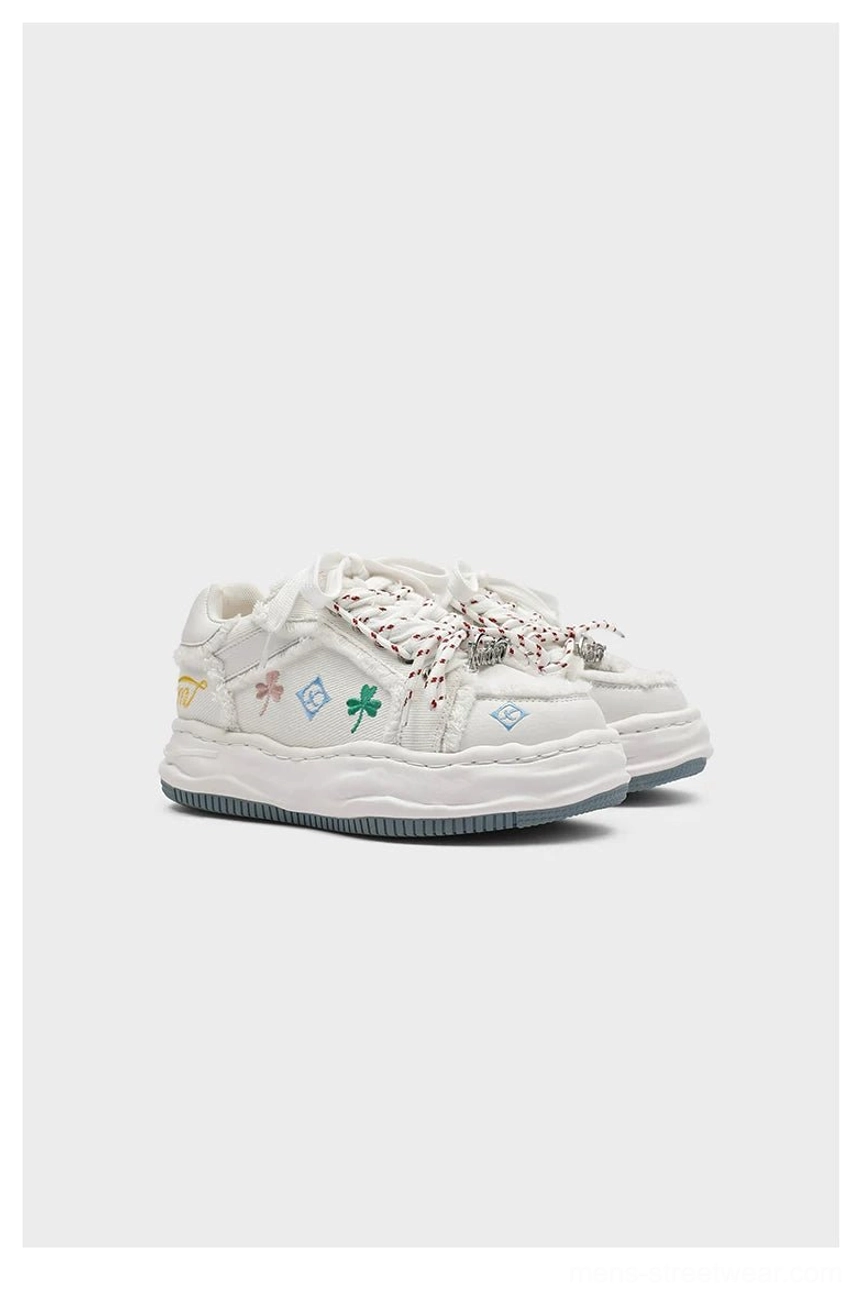 Distressed embroidered platform sneakers with layered mixed-material upper chunky rope laces and elevated streetwear sole