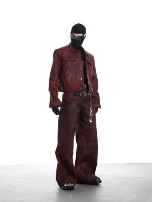 Burgundy distressed faux leather cropped trucker jacket styled with matching wide-leg trousers in a full-body streetwear outfit