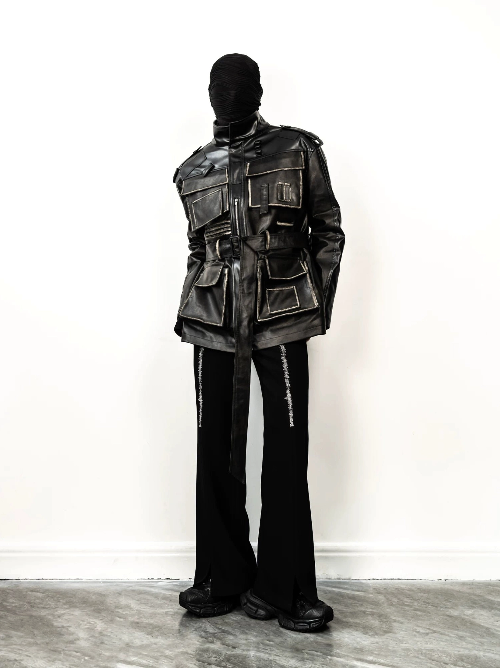 Side view of longline distressed faux leather utility jacket with adjustable waist belt and cargo pocket details