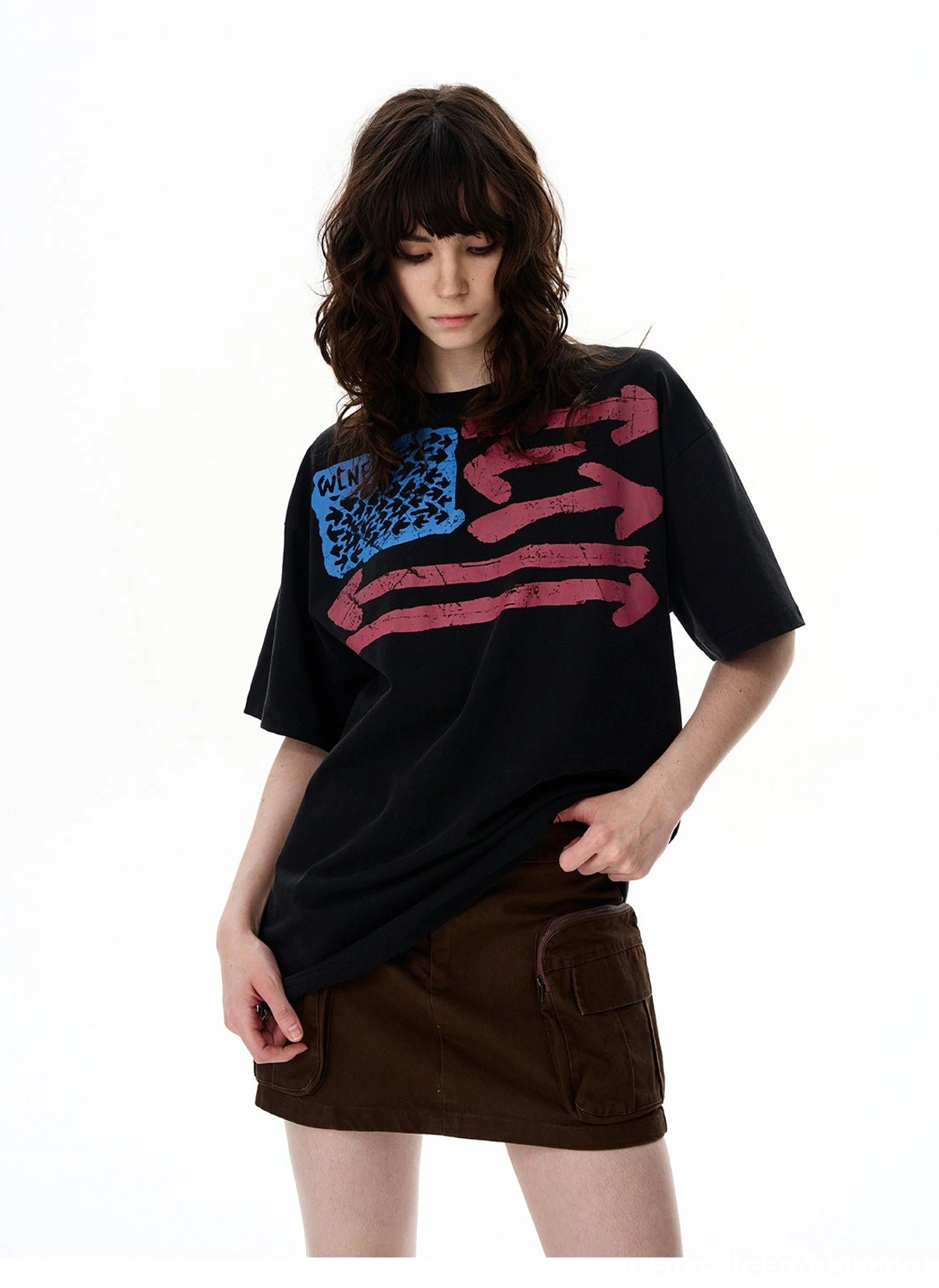 Close-up front view of a distressed flag graphic on a black washed heavyweight cotton oversized streetwear T-shirt