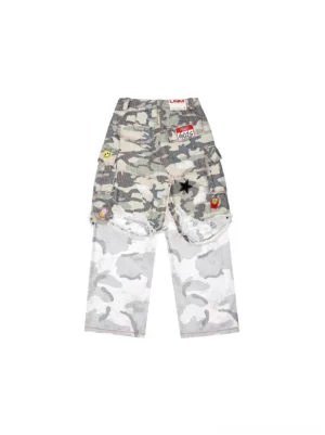 Back view of gray camo cargo pants showing distressed knee areas, patchwork label details, decorated back pockets, and oversized streetwear silhouette