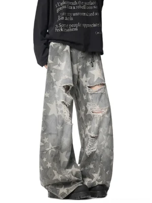 Distressed grey star print wide leg baggy jeans front three quarter view with ripped thigh and knee details