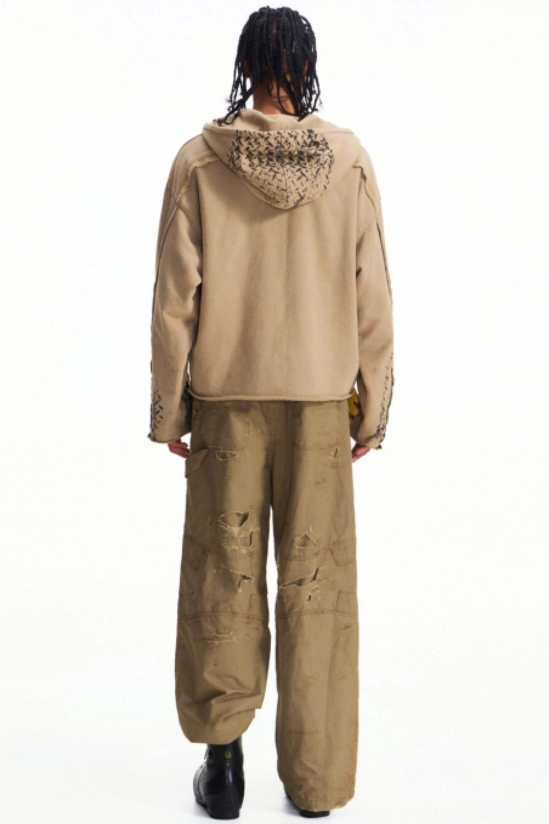 Rear full-body view of khaki distressed wide-leg cargo pants styled with a matching khaki hoodie and black combat boots
