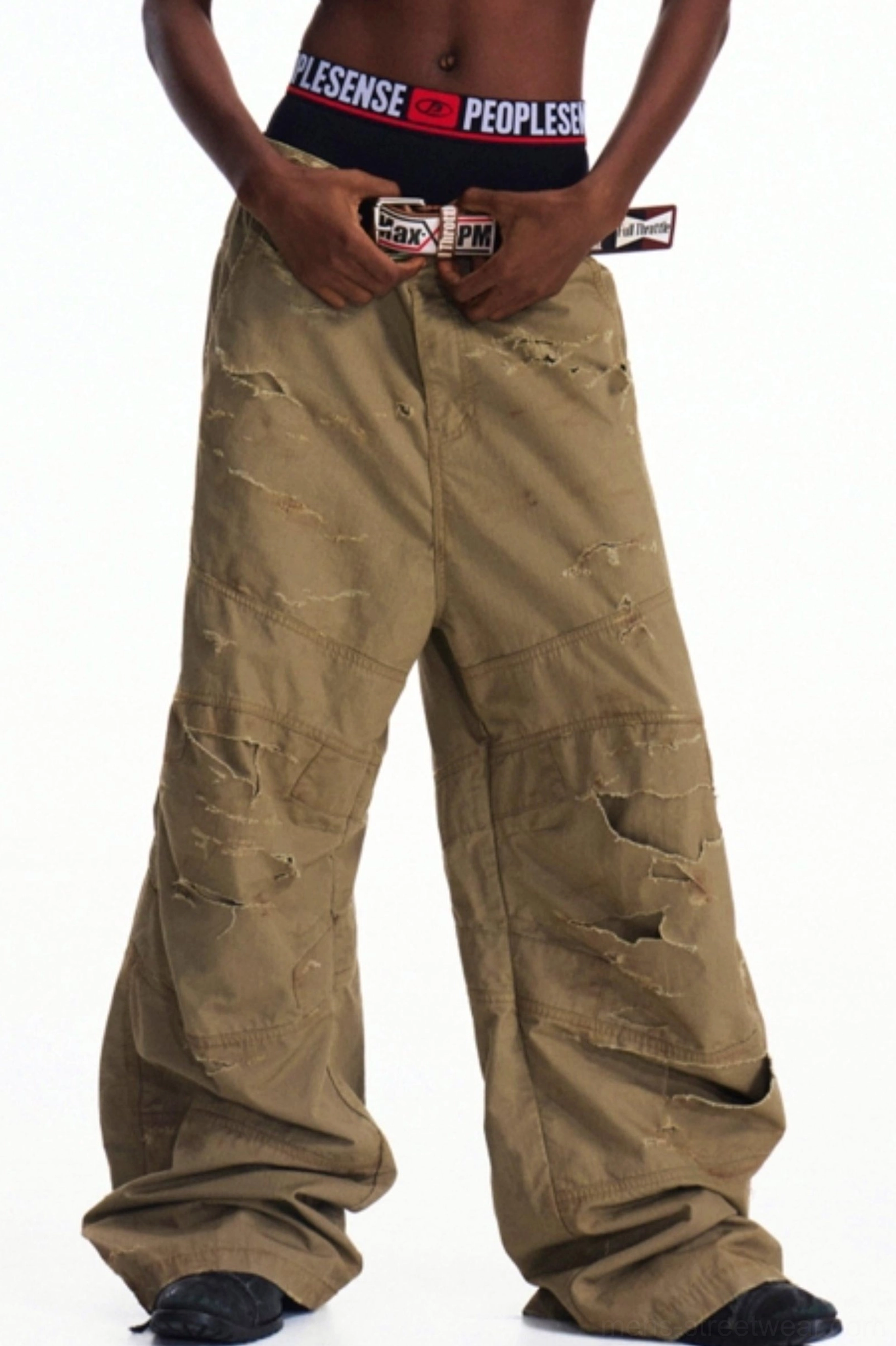 Front view of distressed khaki oversized cargo pants with loose wide-leg silhouette, utility pockets, and vintage worn finish
