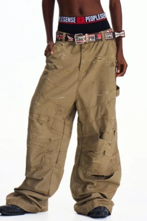 Distressed khaki wide-leg utility cargo pants shown in left three-quarter view with oversized side pockets and frayed streetwear detailing