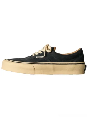 Black distressed genuine leather and canvas low-top sneakers with cream rubber outsole and matching laces on a white background