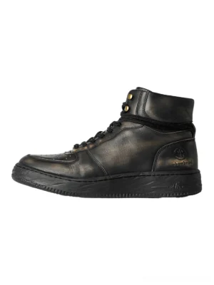 Distressed black leather combat boots with padded ankle cuffs gold-tone studs perforated toe panels and flat rubber soles