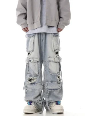 Light blue distressed multi-pocket wide-leg cargo jeans with ripped denim panels and drawstring hems front view