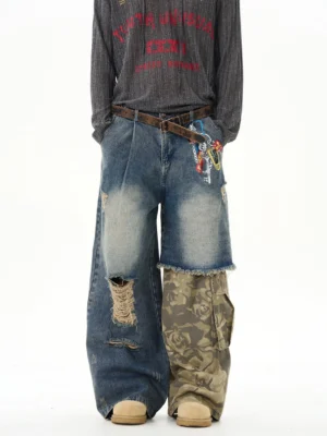 Front view of distressed patchwork wide-leg camo cargo denim jeans on a male model with vintage blue wash ripped details and utility keychain accents