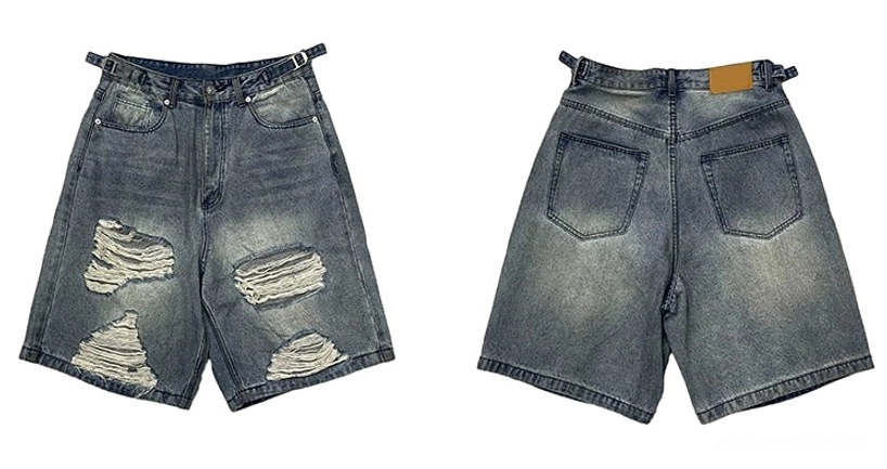 Flat lay front and back view of distressed ripped blue denim Bermuda shorts featuring faded wash, ripped patches, waistband, and classic jean pockets
