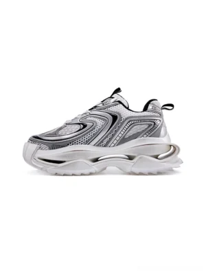 Side three-quarter view of distressed silver chunky dad sneakers with textured metallic upper, rippled overlays, sculpted translucent-looking sole, and rear pull tab