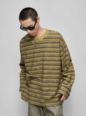 Olive brown beige distressed stripe oversized long sleeve crew neck streetwear top front three-quarter view male model layered silver necklaces sunglasses