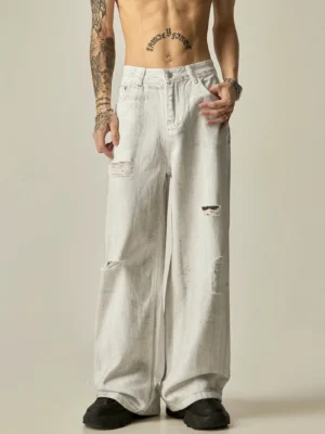 Front full-body view of distressed white wide-leg acid wash denim jeans with ripped details