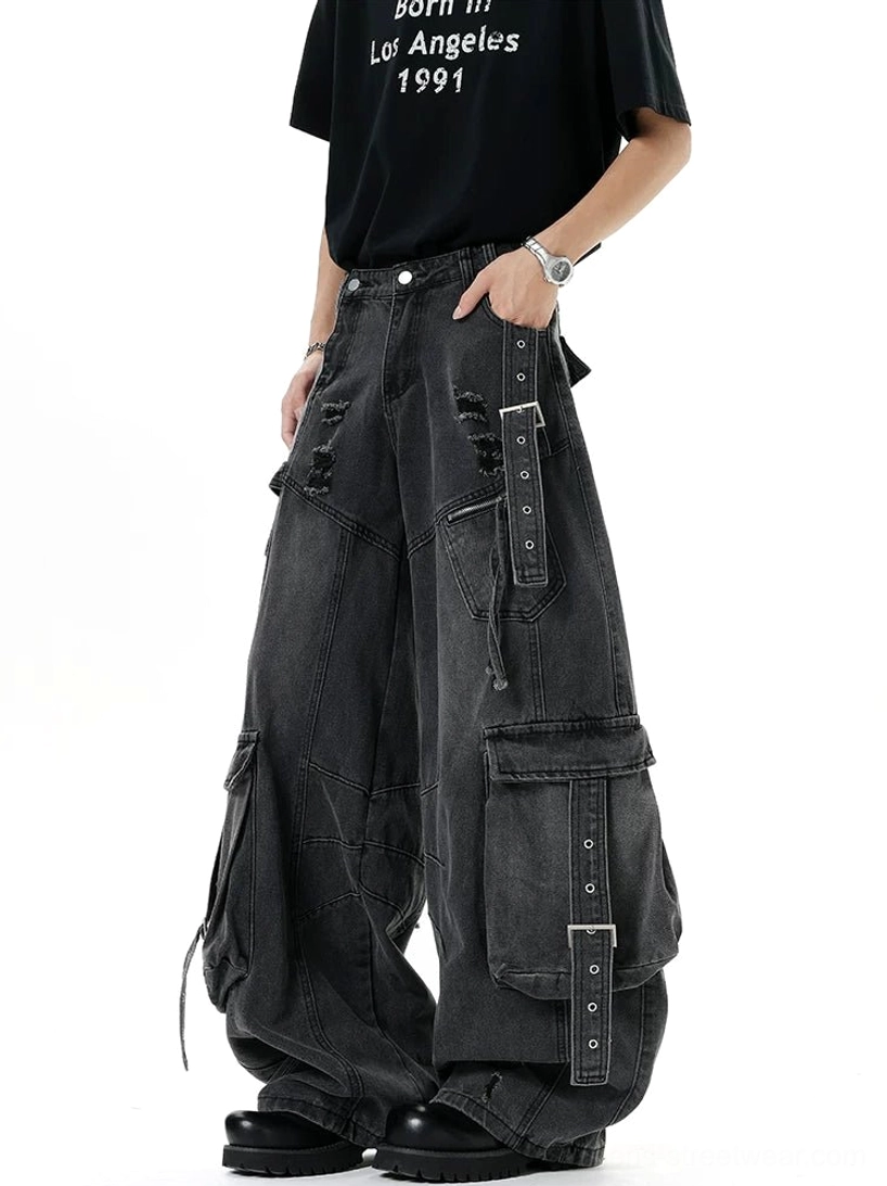 Distressed wide-leg cargo denim pants with utility straps, oversized pockets, ripped details, and contemporary Y2K streetwear design