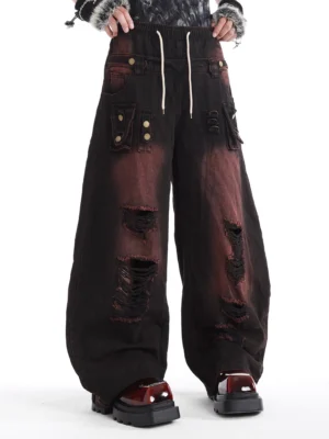 Back view of relaxed distressed wide-leg denim cargo pants with elastic drawstring waistband oversized pockets and ripped detailing