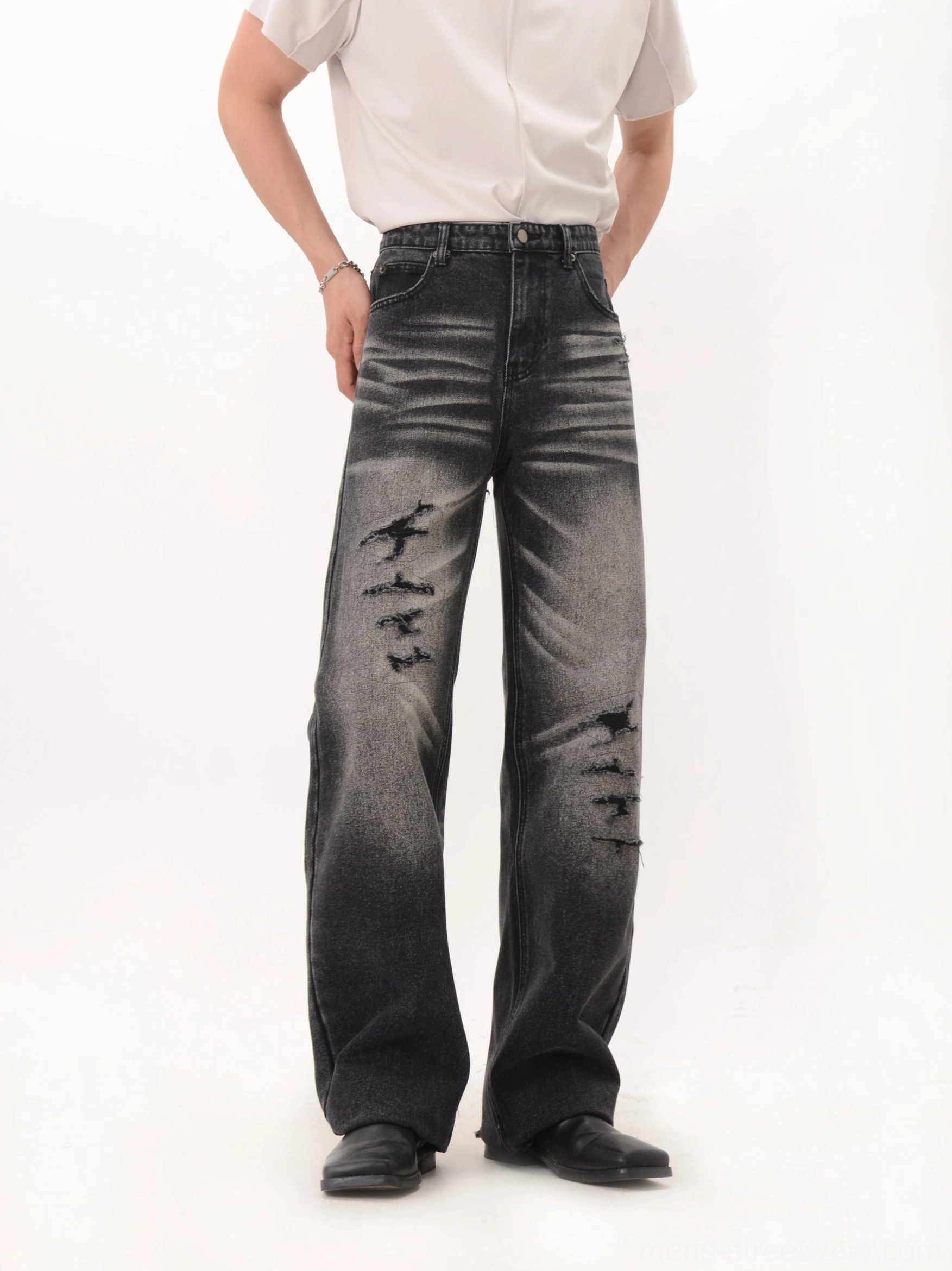 Dark faded black wide-leg distressed denim jeans front view with ripped knees and vintage gradient wash