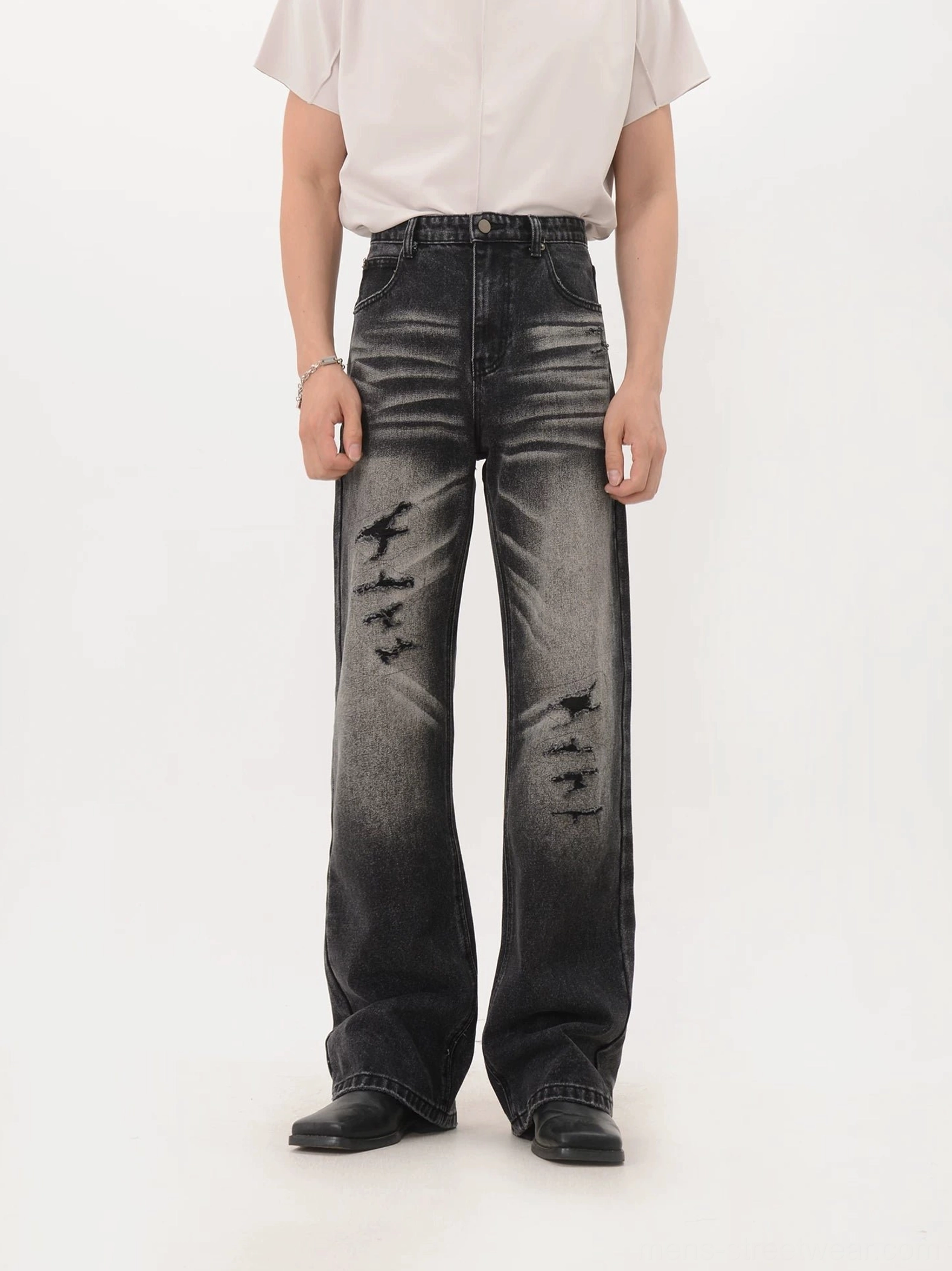 Faded black distressed wide-leg denim jeans with ripped thigh and knee details front view