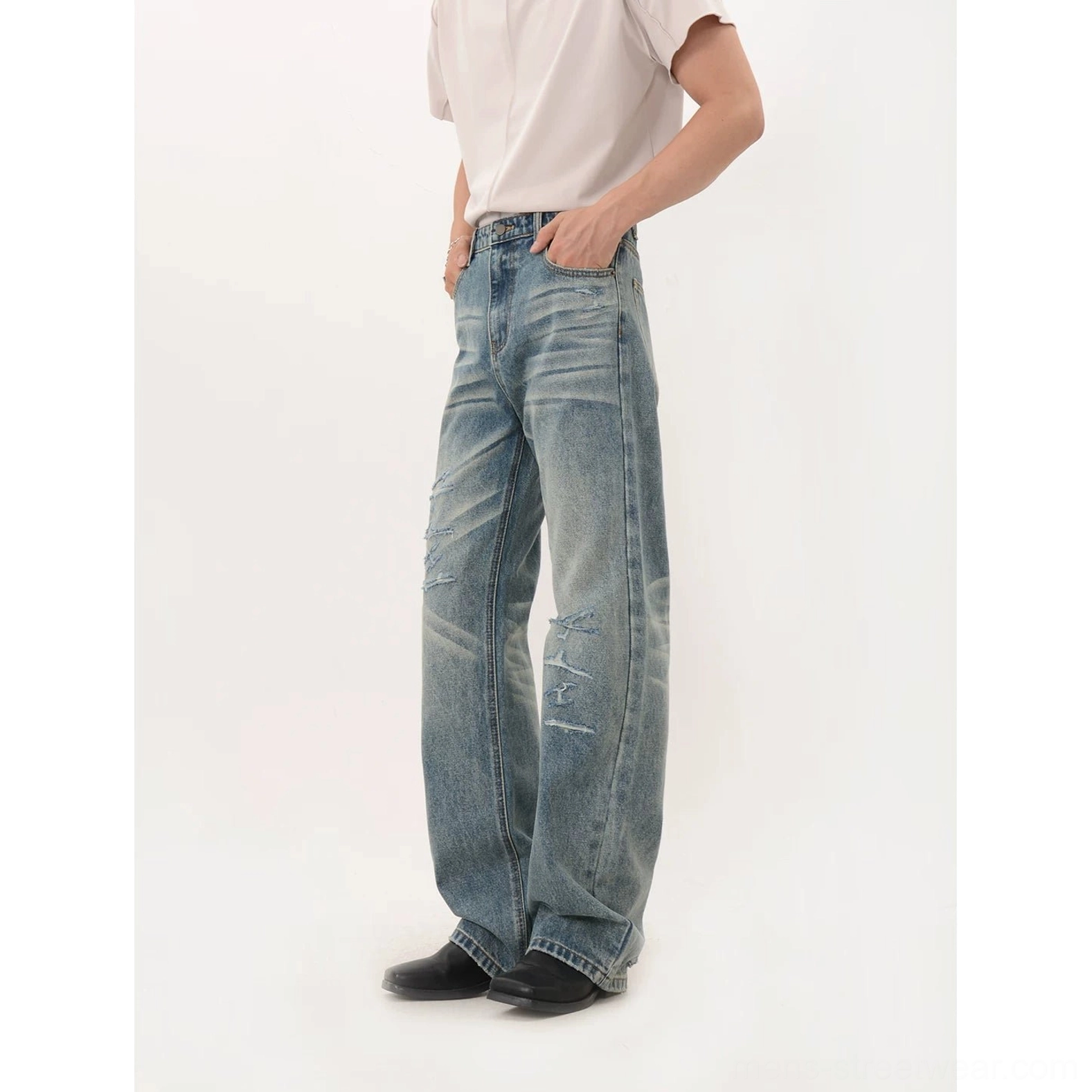 Vintage blue distressed wide-leg denim jeans with faded wash and relaxed full-length streetwear silhouette