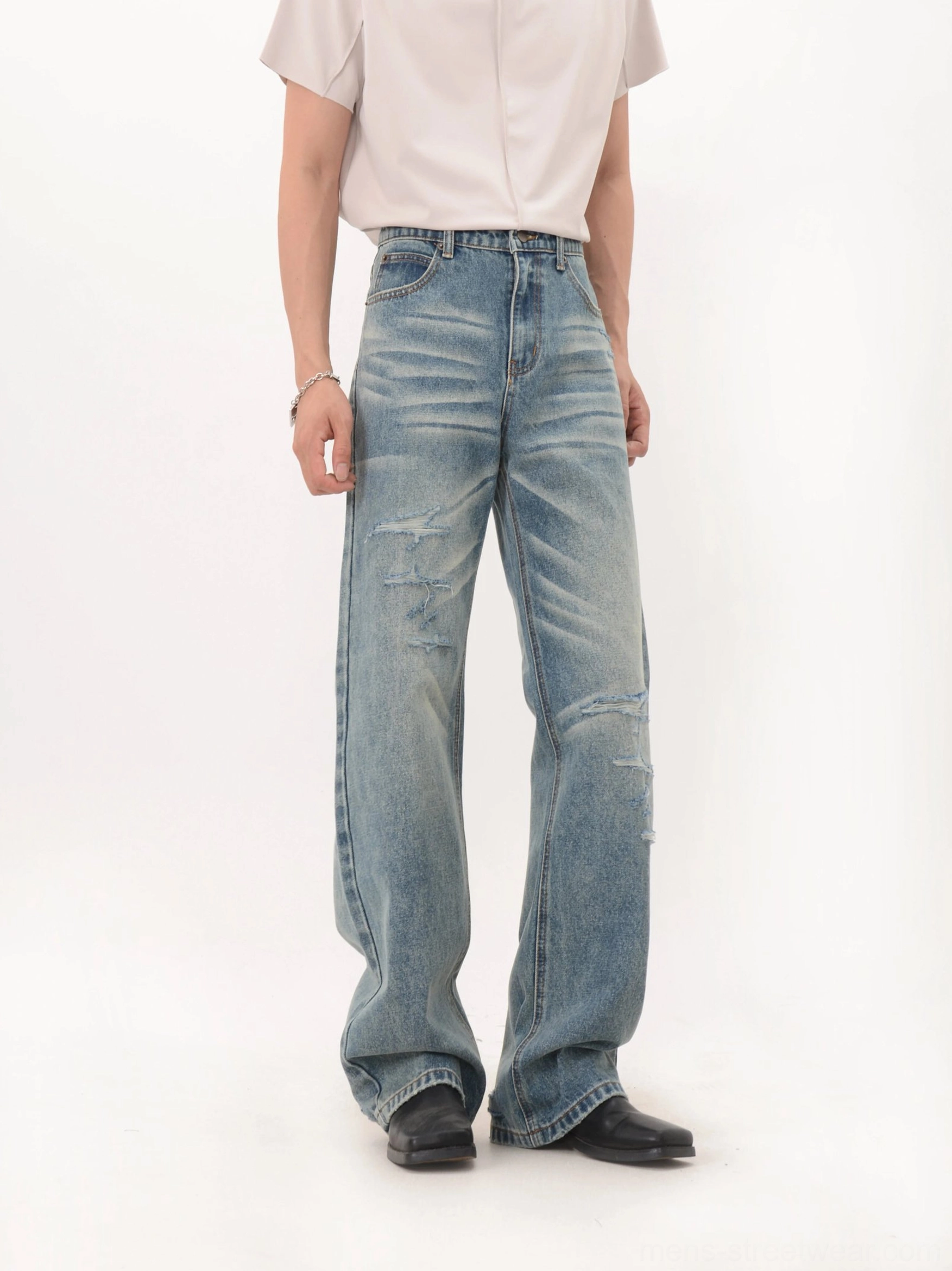Light vintage blue wide-leg denim jeans with subtle distressed details and relaxed high-waist silhouette
