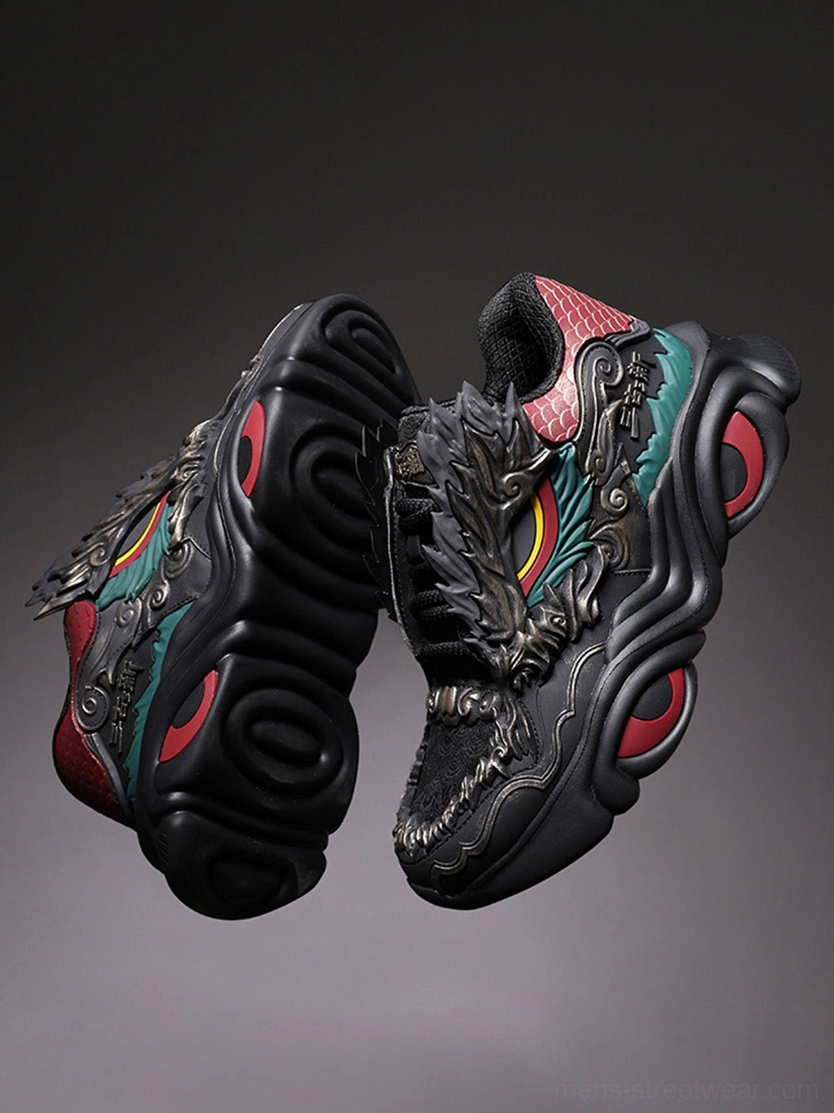 Pair of black dragon crest chunky runner sneakers top view showing matching dragon motifs teal panels and red outsole accents