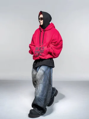 Dragon Fruit red oversized graphic hoodie side view with dark self expression slogan artwork and baggy Korean streetwear fit