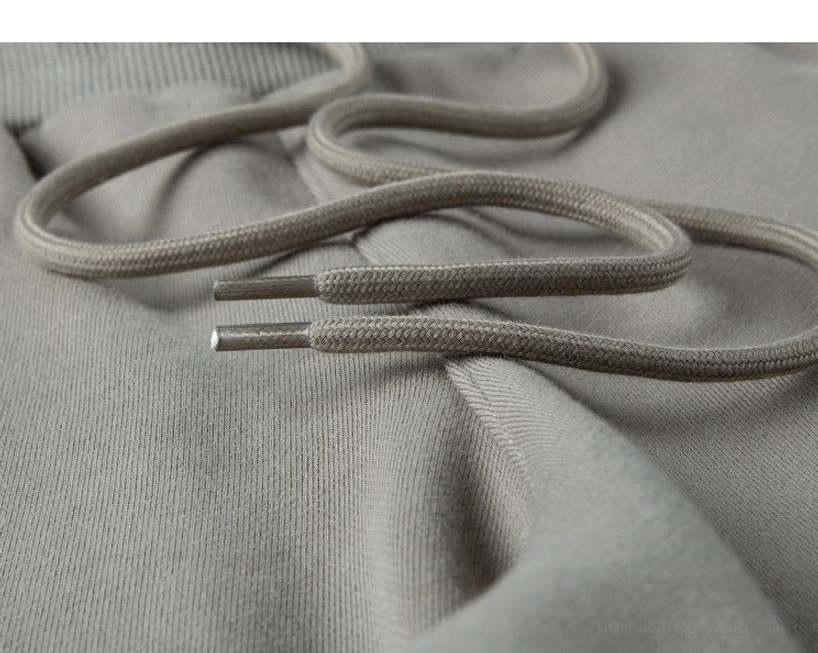 Flat lay close-up drawcord detail braided round drawstring metal aglet tips premium construction soft knit shorts fabric underneath