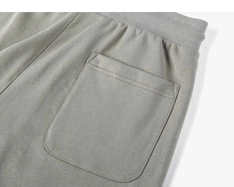 Raw cut hem detail oversized drawstring shorts unfinished edge contemporary streetwear design minimal aesthetic detail shot