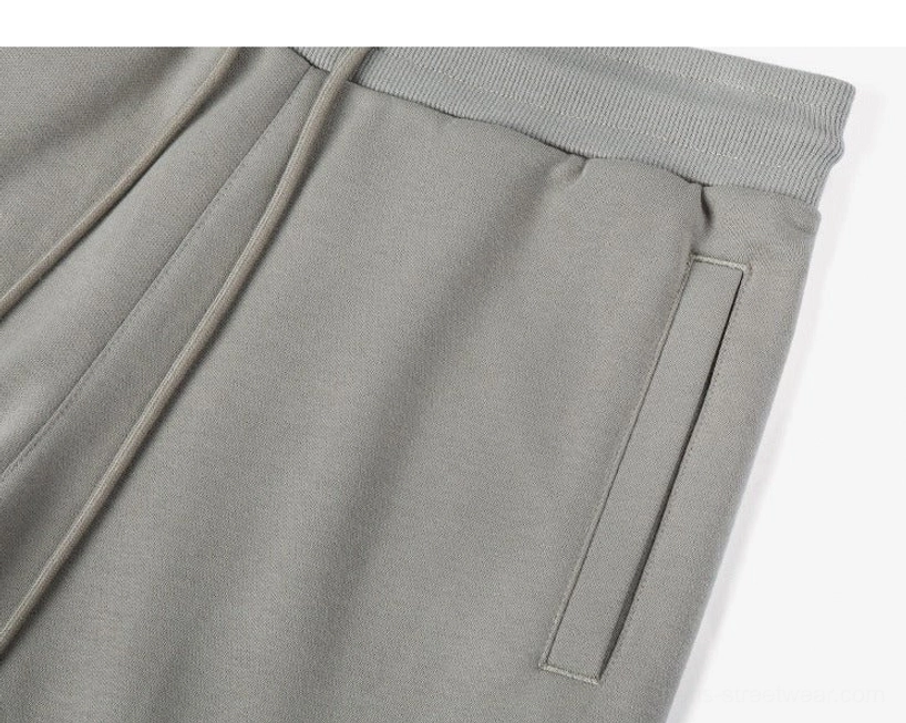 Close-up side view drawstring sweat shorts detail taupe grey side pocket smooth knit fabric texture waistband design streetwear