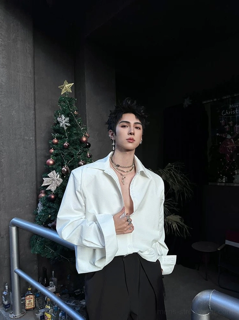 White oversized cuff shirt styled with an open collar and extended wide cuffs in a Korean streetwear outfit