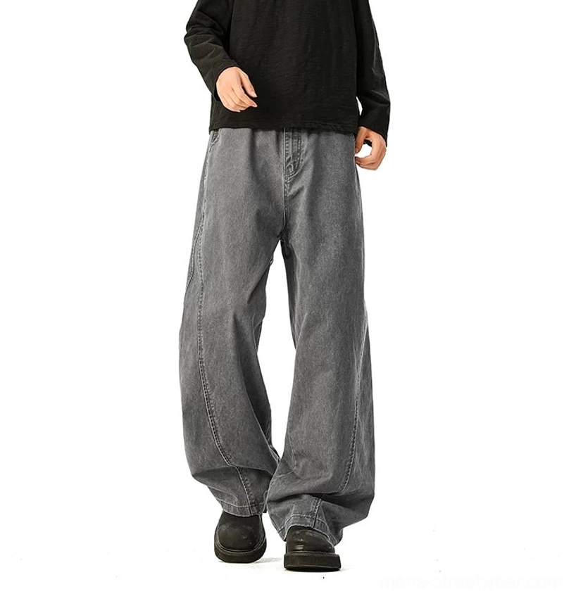 Faded grey ultra-wide denim jeans front standing full-length male model, classic waistband