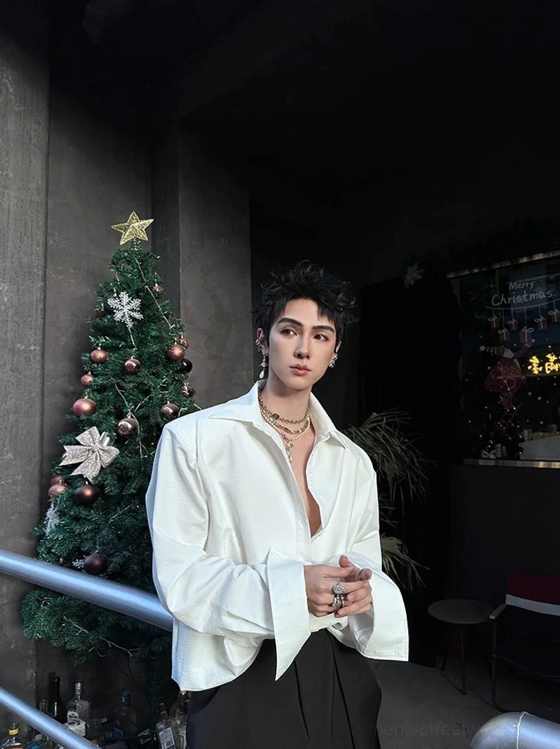 White oversized long-sleeve streetwear shirt with folded wide cuffs and black straight-leg pants